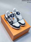 White and navy Louis Vuitton Trainer-style sneakers displayed on an orange box