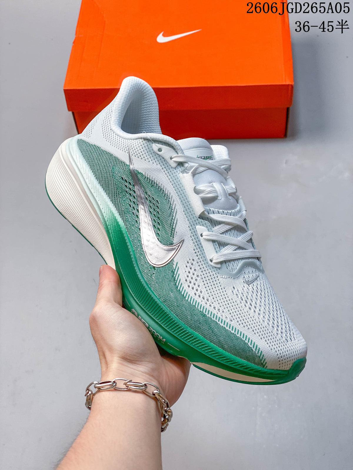 White Nike Pegasus 42 running shoe with green side accents, shown in profile.