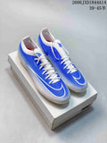 Pair of blue-and-white Nike Mercurial soccer cleats shown on a box; image text shows a size range of 39–45 with half sizes.
