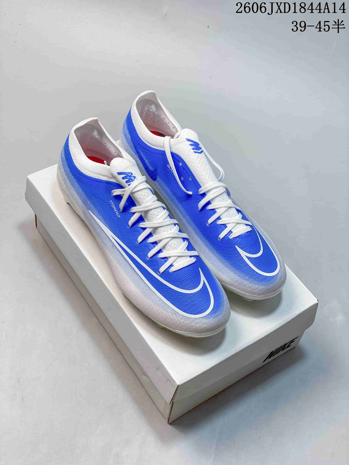 Pair of blue-and-white Nike Mercurial soccer cleats shown on a box; image text shows a size range of 39–45 with half sizes.