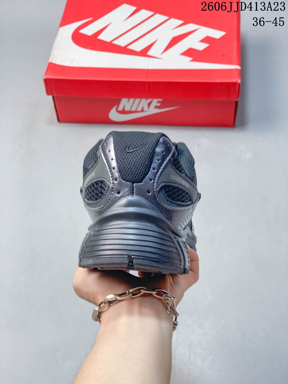 Rear view of a dark charcoal Nike Air Zoom Winflo 12 shoe