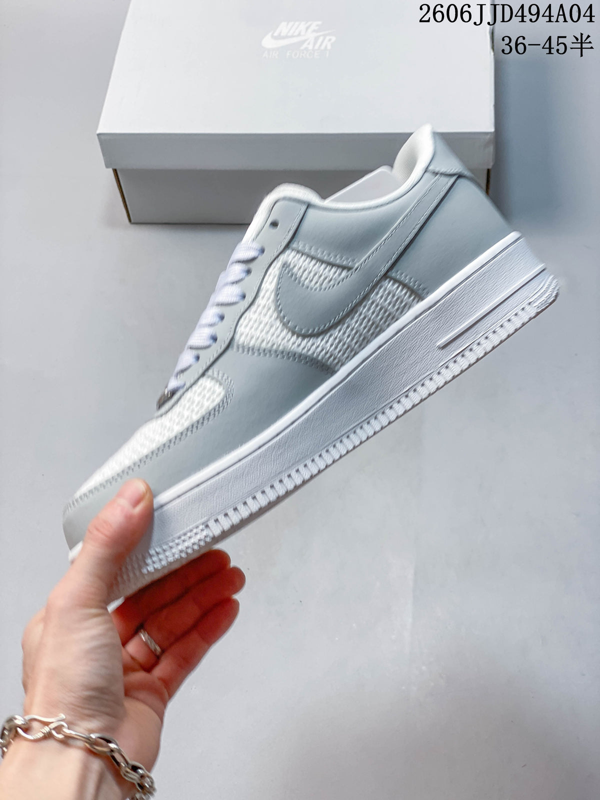 Side profile showing the light gray overlays, textured white panels, and Swoosh