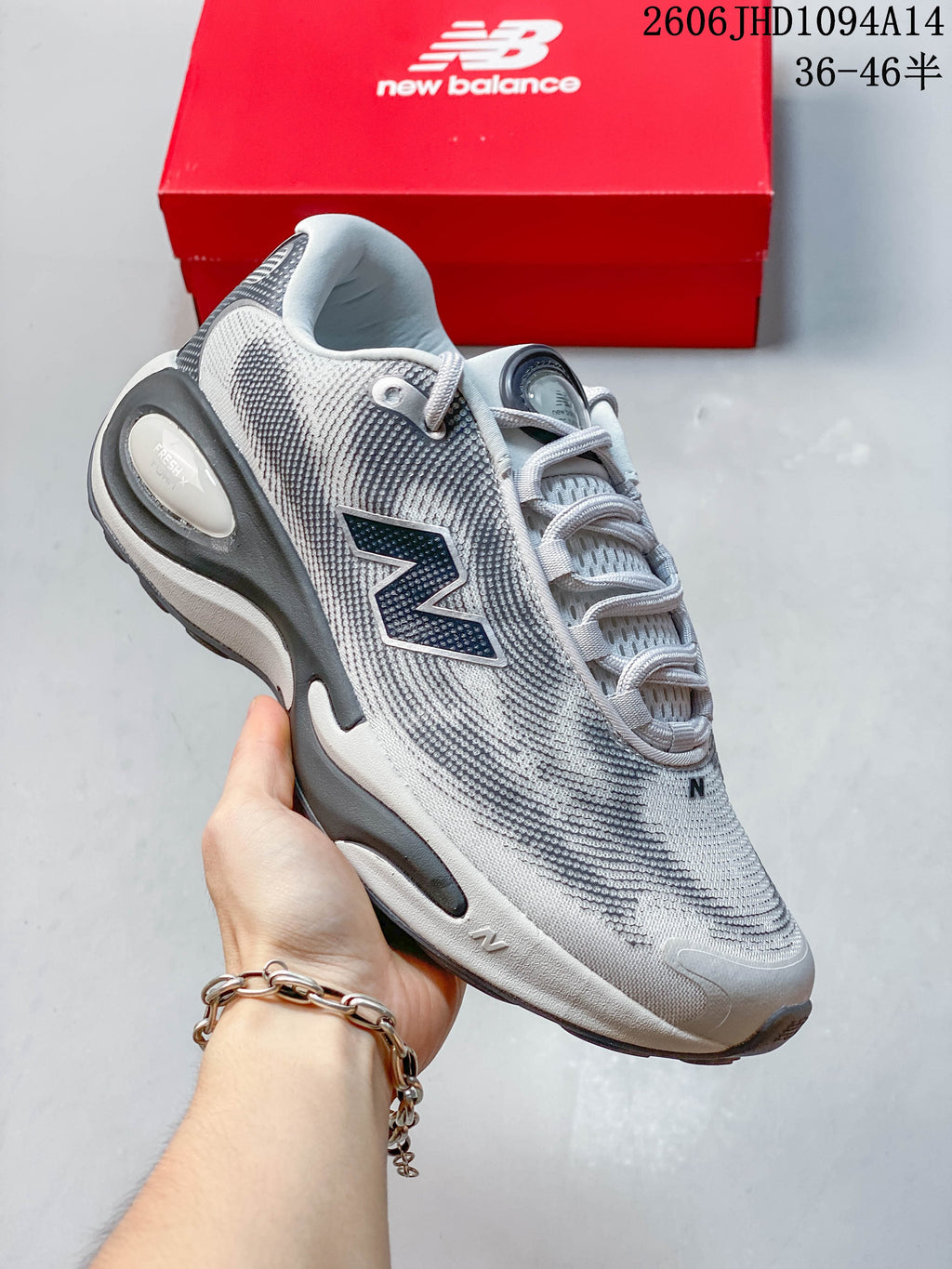 Side view of a light gray New Balance AC Runner shoe with dark accents.