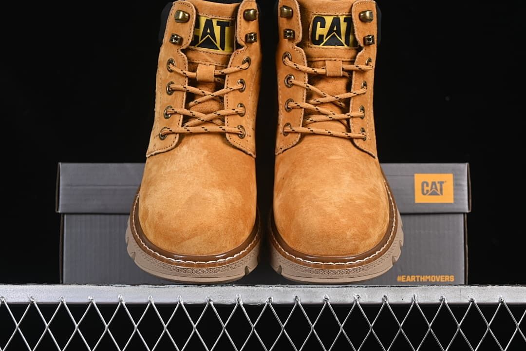 Front view of the pair of wheat-colored lace-up boots