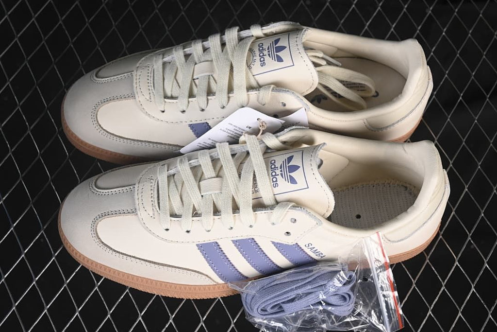 Pair of cream and blue Samba OG sneakers with an extra set of blue laces