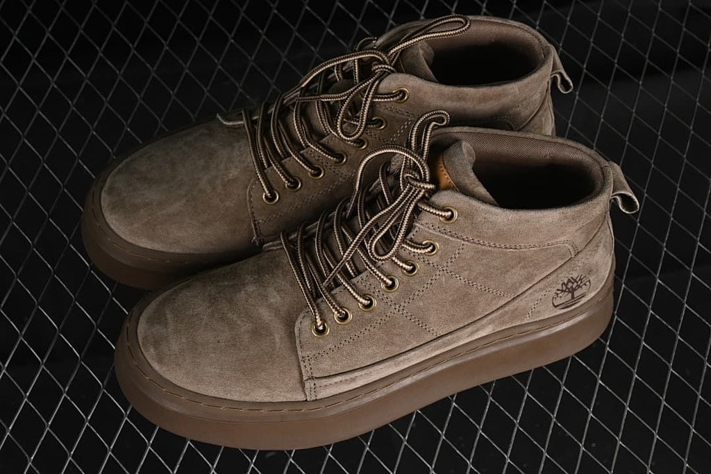 Pair of khaki mid-top lace-up boots viewed from above at an angle