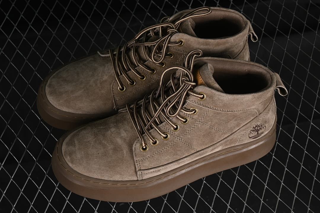 Pair of khaki mid-top lace-up boots viewed from above at an angle