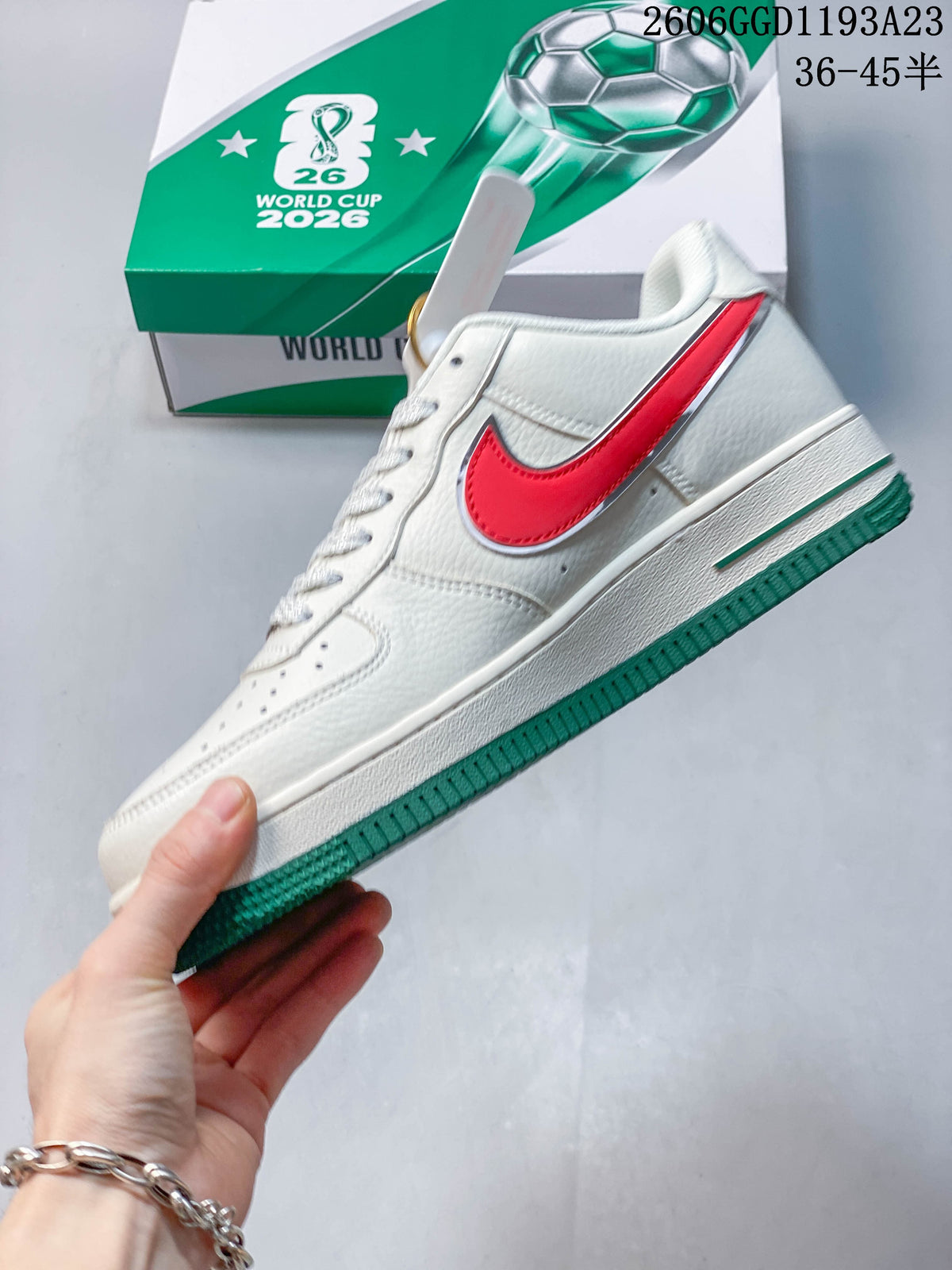 Side view of white sneakers with red accents and a green outsole