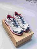 Pair of white Salomon XA Pro 3D trail running shoes with pink and navy accents on a box