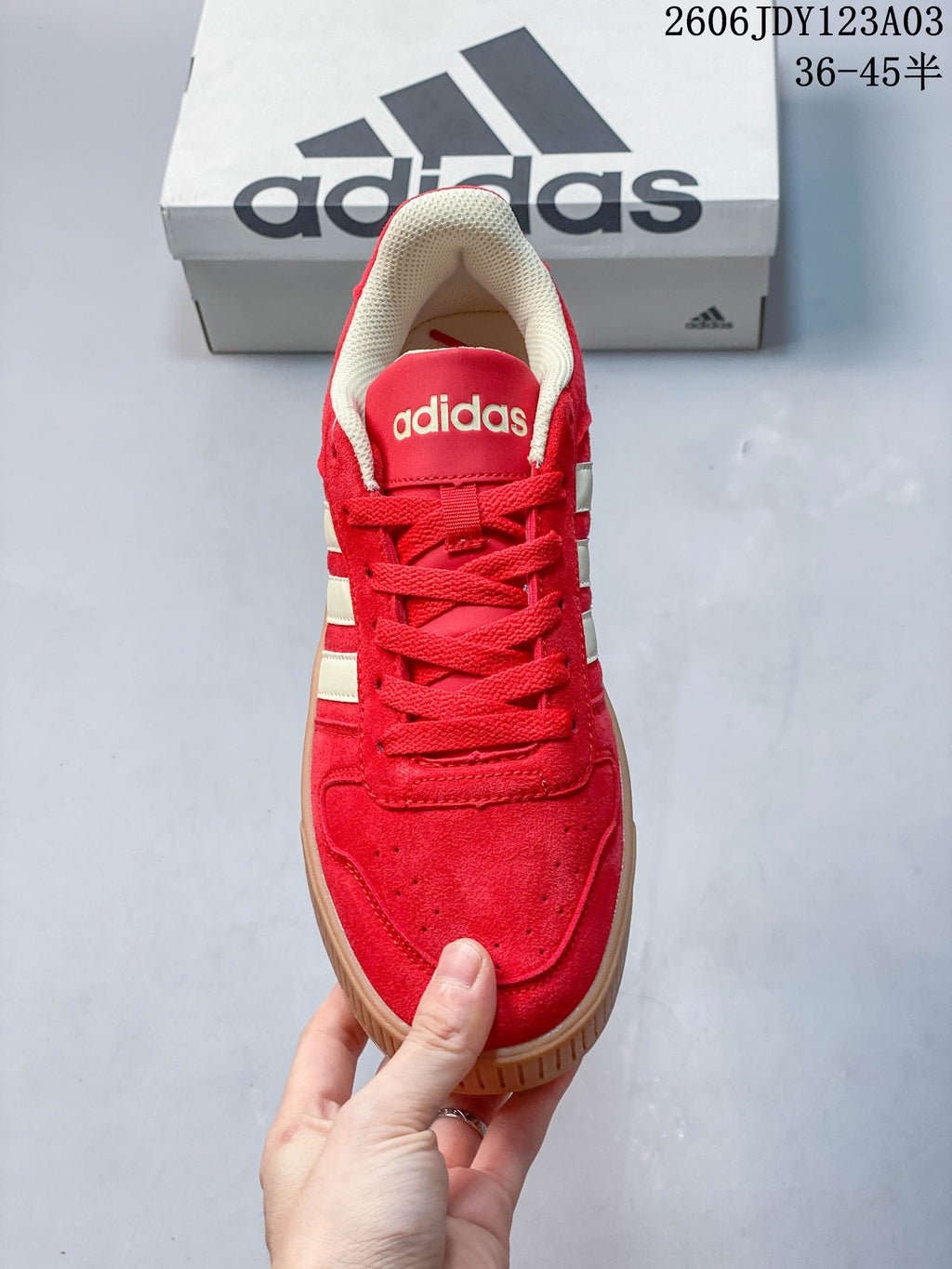 Top view of the red lace-up sneaker showing the perforated toe and padded collar