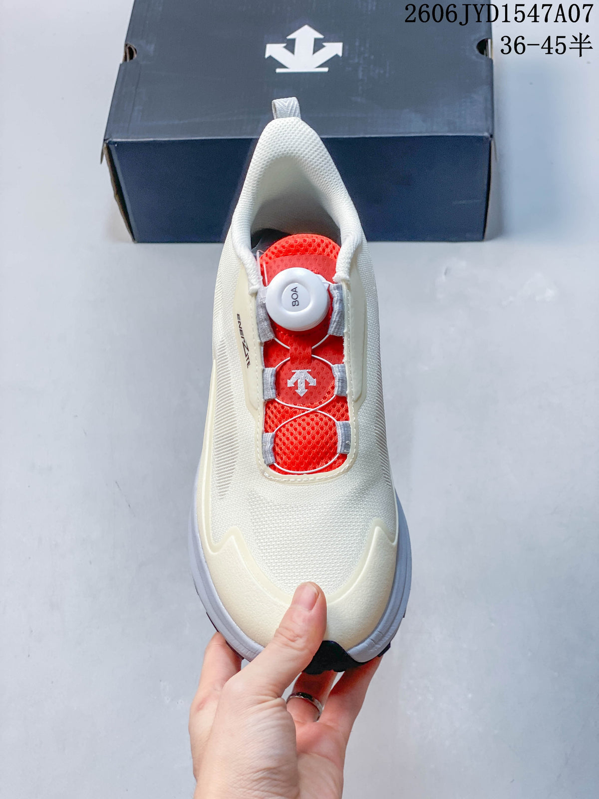 Top view of a cream DESCENTE shoe showing its red tongue and dial-adjustable closure.
