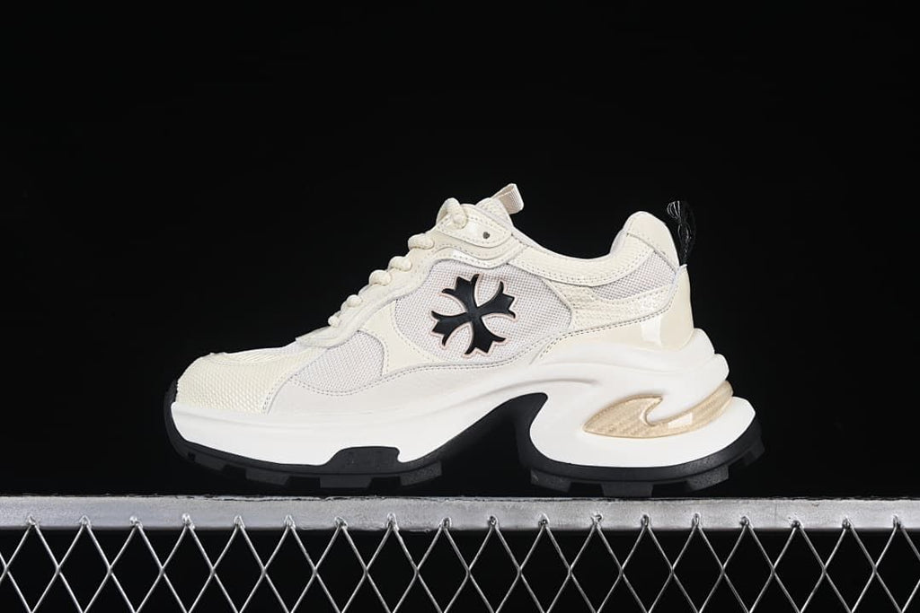 Side view of one beige sneaker against a dark background