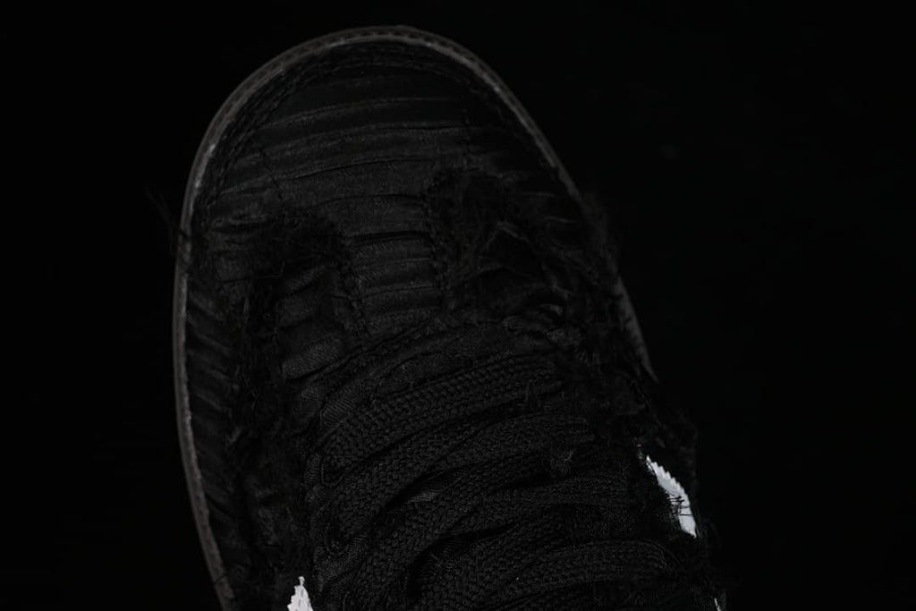 Top view of the black lace-up sneaker and textured toe