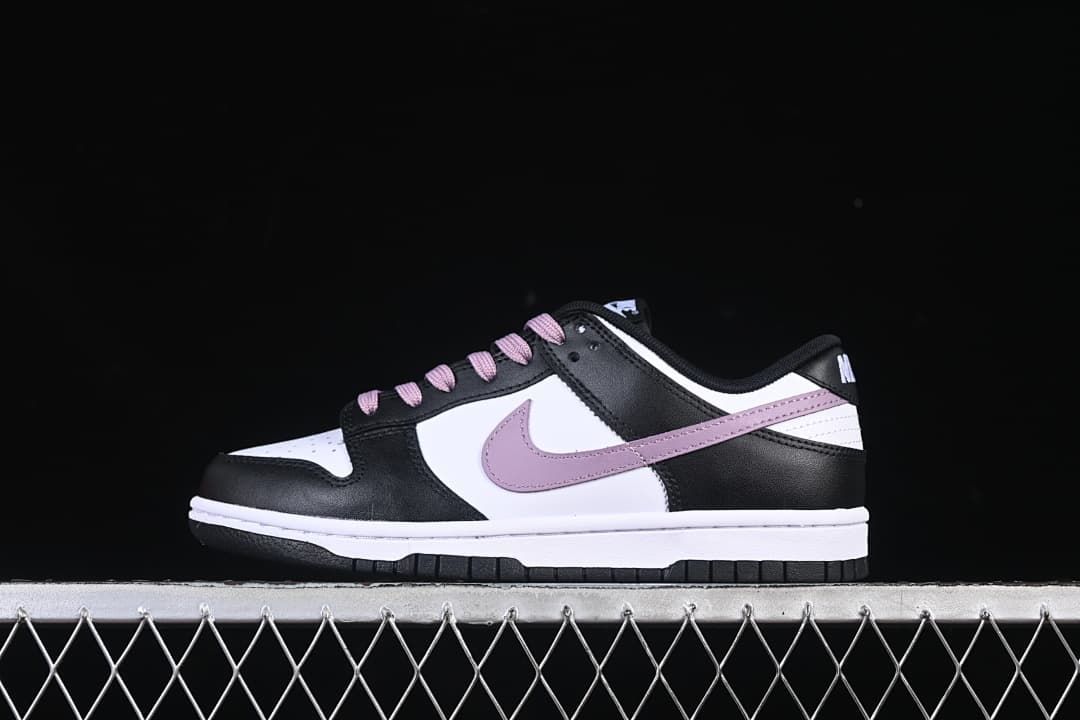 Side view of a black and white low-top sneaker with purple accents