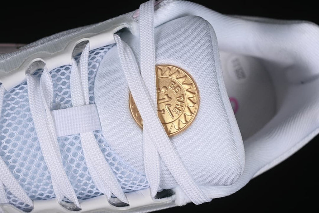 Close-up of laces, mesh tongue panel, and gold-colored tongue emblem
