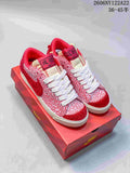 Red-and-white patterned Nike Blazer Low Jumbo sneakers with white laces