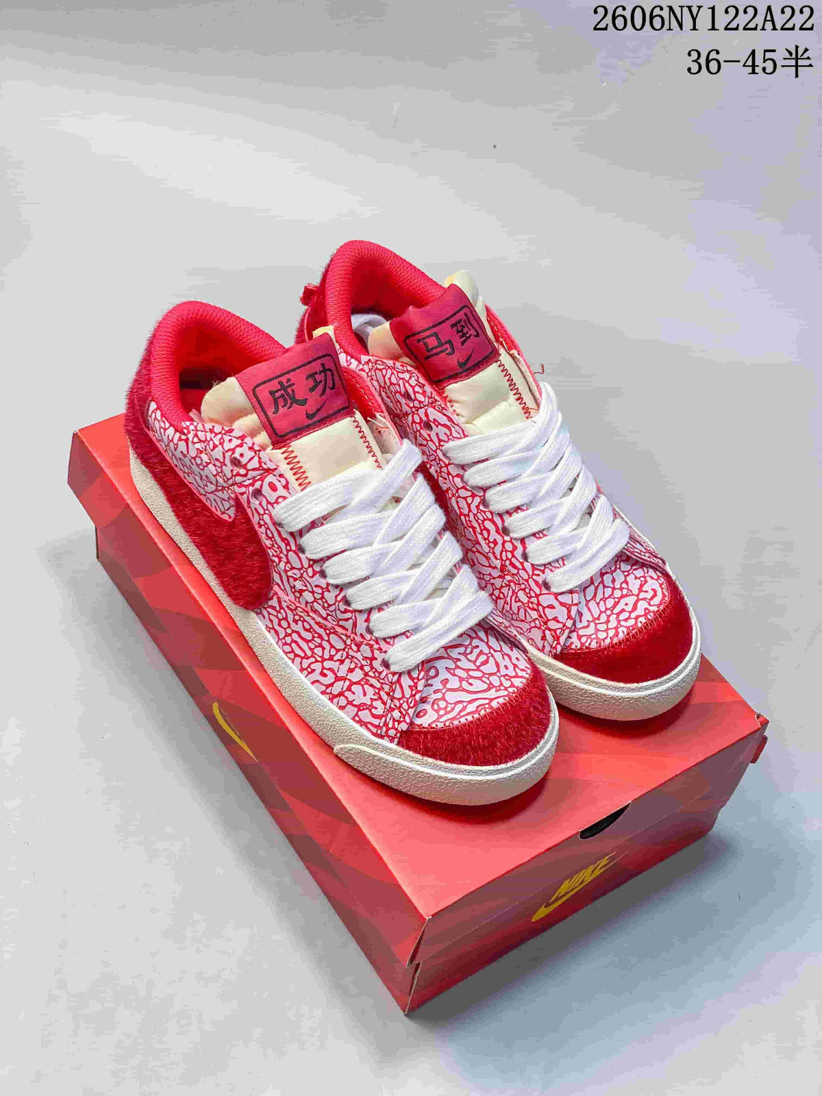 Red-and-white patterned Nike Blazer Low Jumbo sneakers with white laces