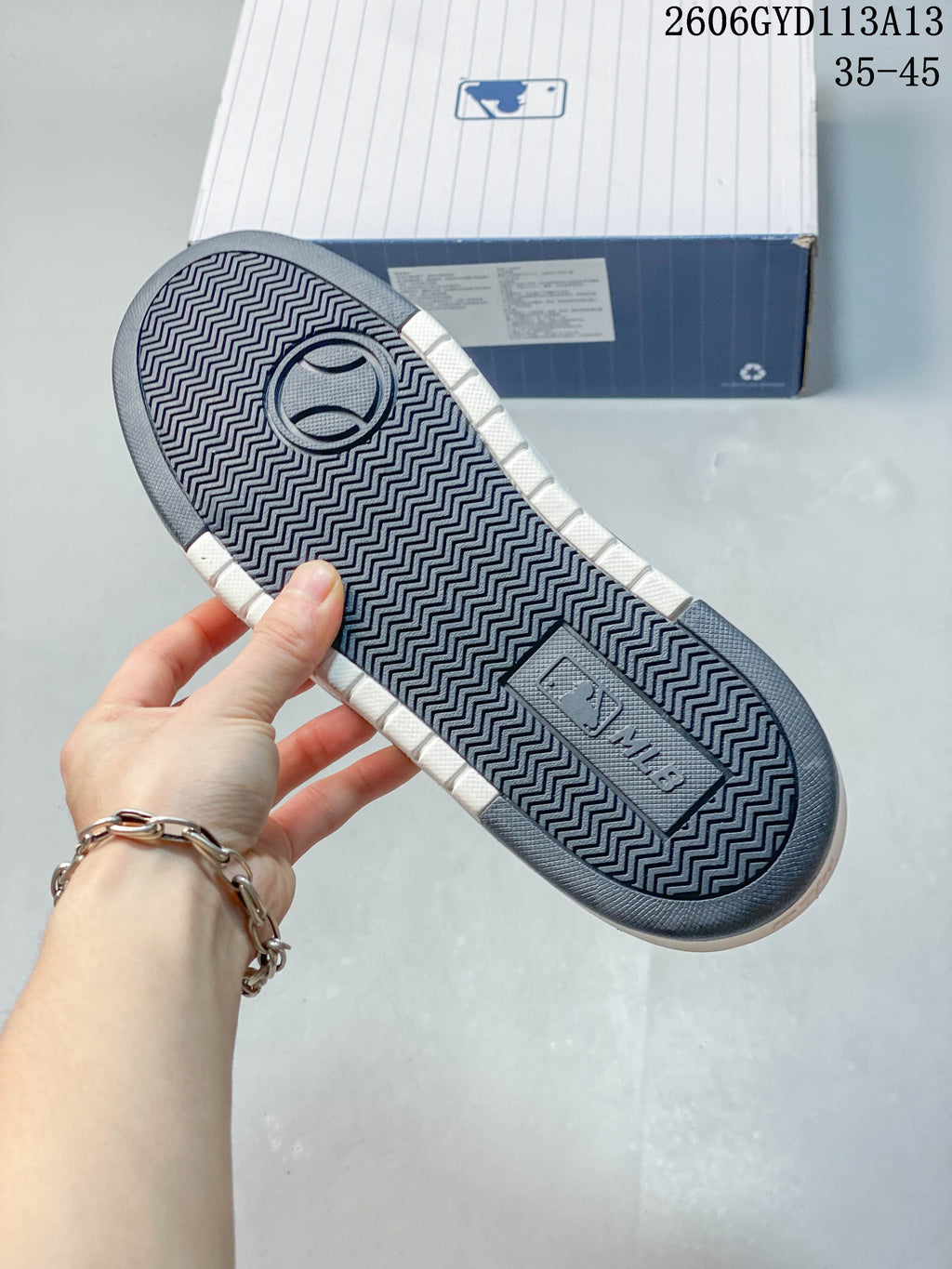 Underside of the sneaker showing a patterned dark outsole