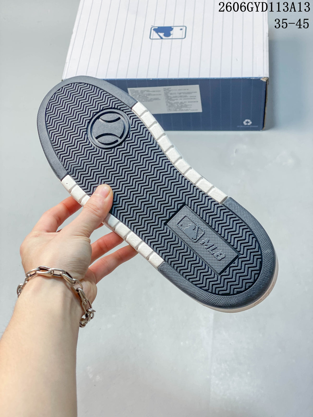 Underside of the sneaker showing a patterned dark outsole