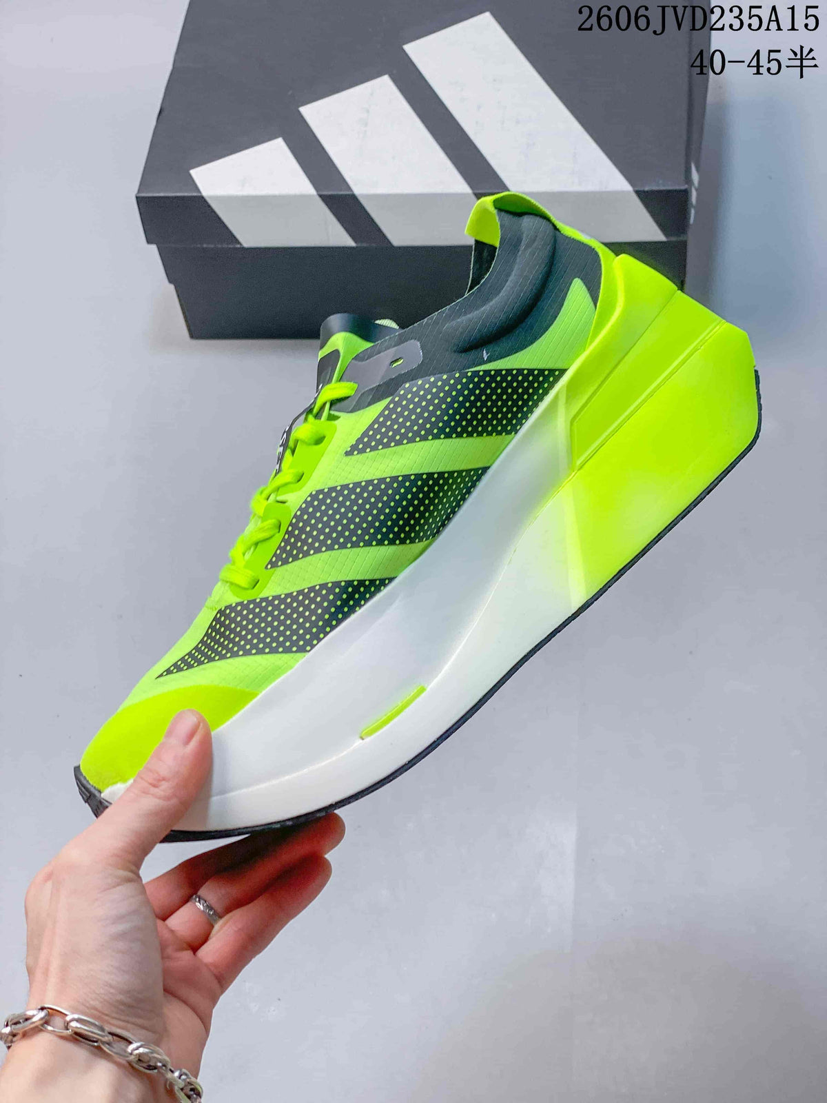 Side view of a neon green shoe with dark graphics and a white midsole