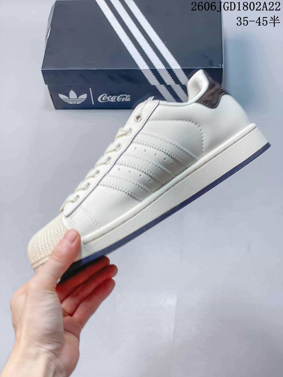 Side view of the off-white low-top sneaker with three-stripe detailing.