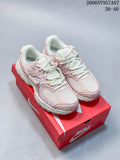 Pair of pale pink and white Nike V5 RNR sneakers displayed on a red shoe box