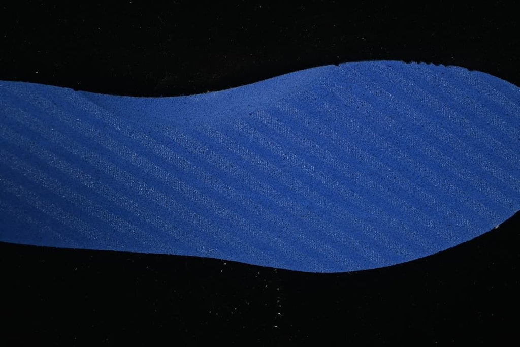 Close-up of a blue shoe component with a textured surface