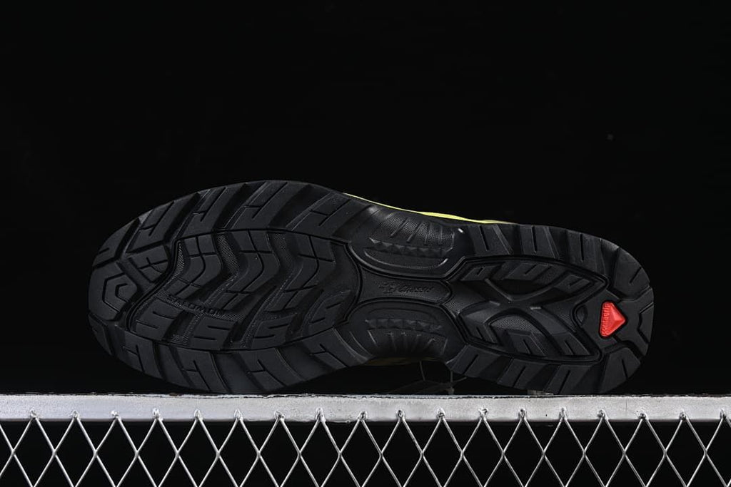 Underside view showing the patterned black outsole and coral-colored detail.