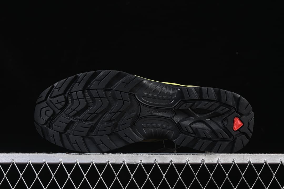 Underside view showing the patterned black outsole and coral-colored detail.