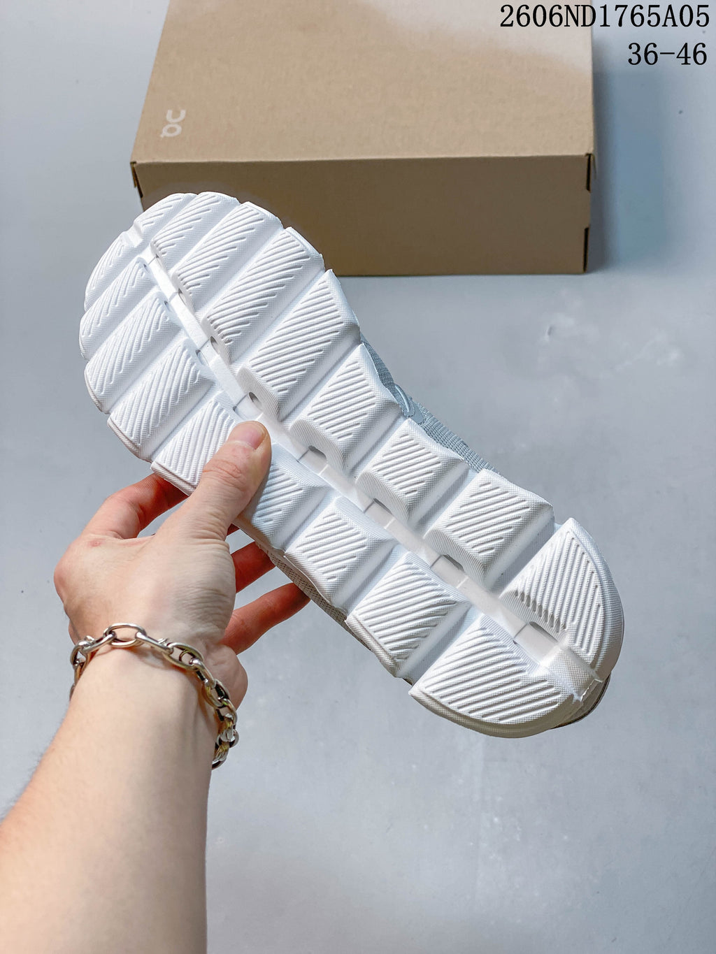 Close-up of the white segmented outsole on an On Cloud 5 sneaker