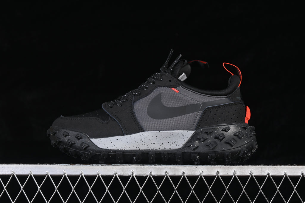Side profile of the black and gray sneaker with orange accents and a speckled midsole