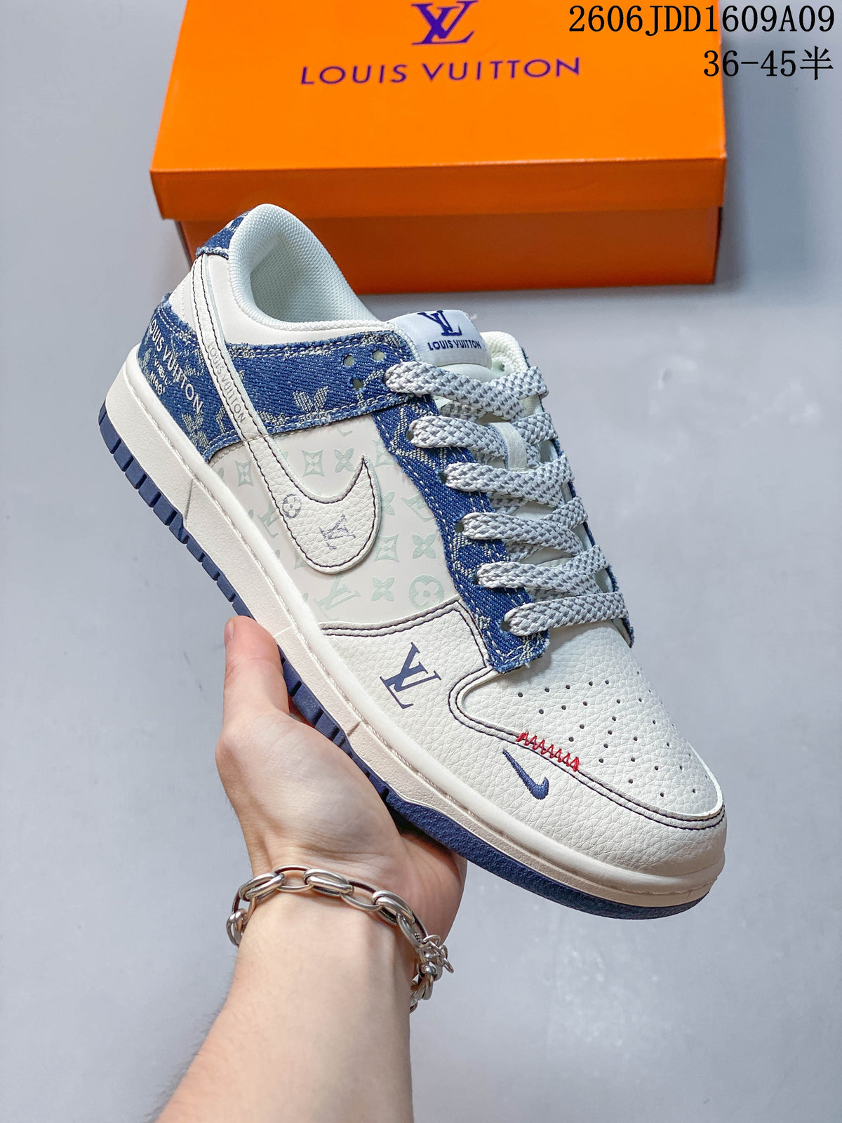 Angled view of the cream and blue sneaker with patterned side panels and contrast stitching