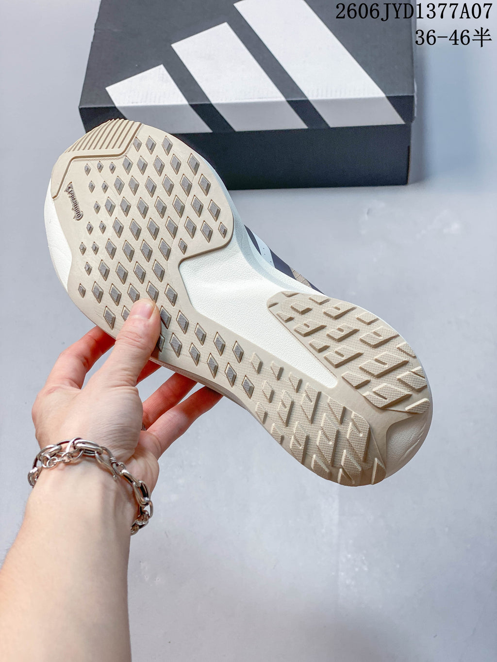 Close-up of the beige patterned outsole on an Adidas Adizero Evo SL shoe.