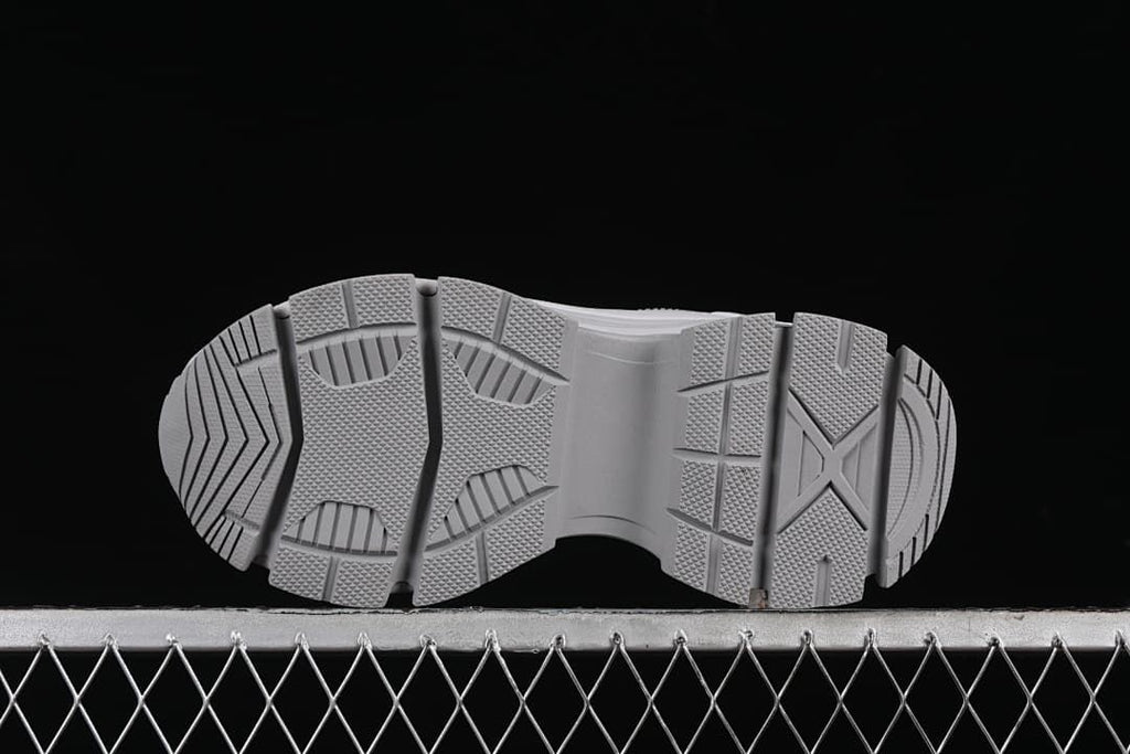 Underside view of the sneaker outsole with patterned tread.