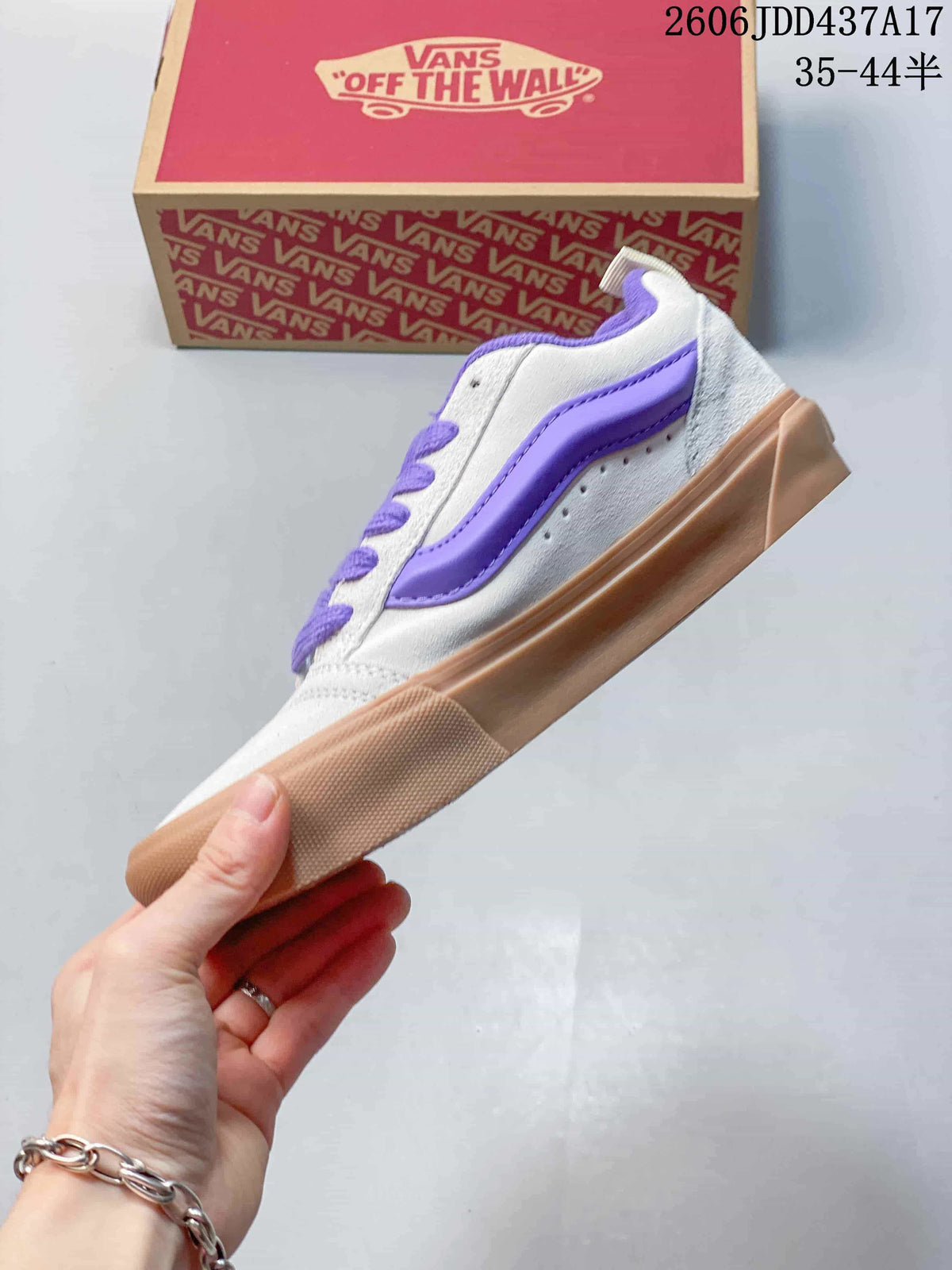 Side profile showing the purple stripe and gum-colored sole of a gray Vans Knu Skool sneaker.