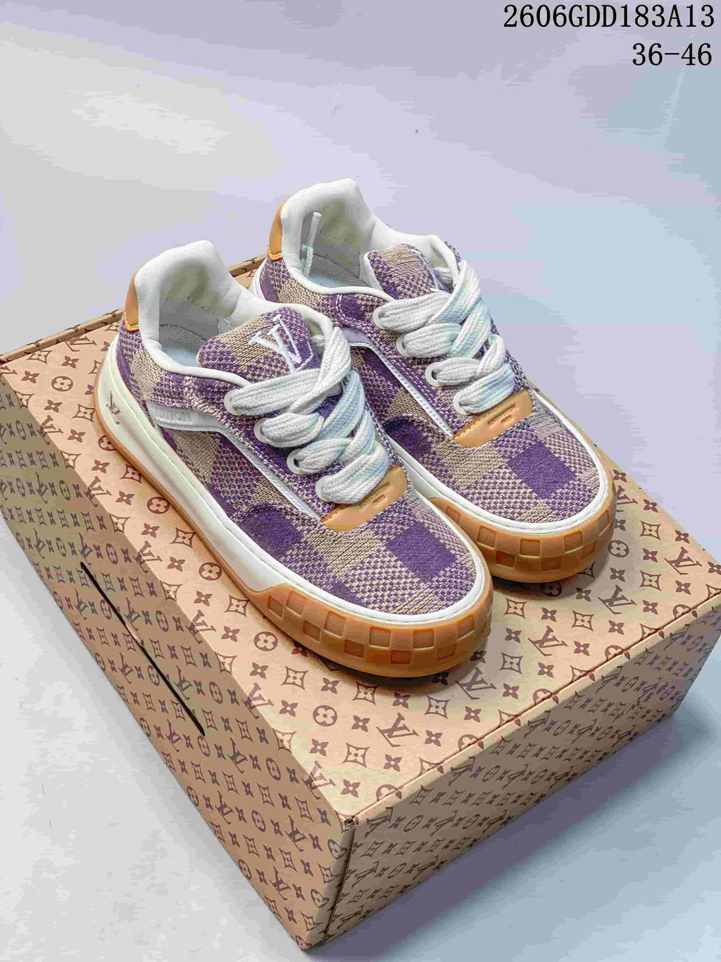 Pair of purple and beige check-patterned low-top sneakers with white laces and tan outsole accents