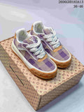 Pair of purple and beige check-patterned low-top sneakers with white laces and tan outsole accents