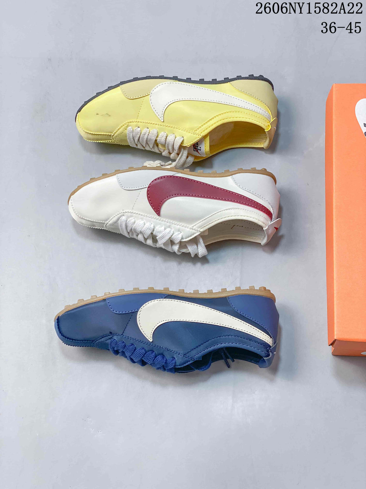 Side views of yellow, white-and-red, and blue Nike low-top sneakers