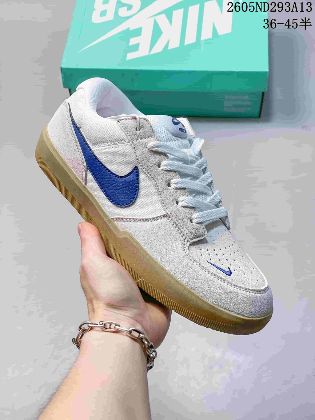 White and light grey Nike SB Force 58 sneaker with a blue Swoosh and gum-colored sole