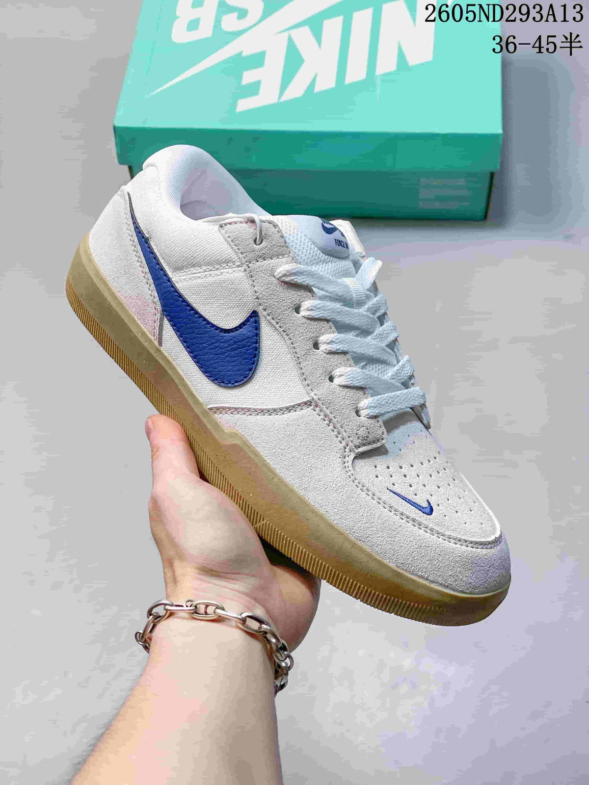 White and light grey Nike SB Force 58 sneaker with a blue Swoosh and gum-colored sole