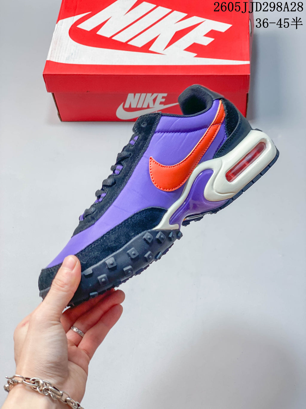 Side view of the purple Nike Air Max Waffle SP with orange accent and visible heel Air unit