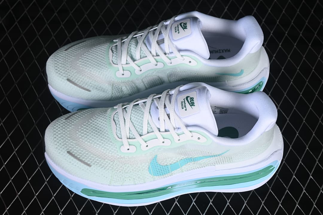 Pair of pale mint Nike Vomero Premium shoes viewed from above and the side
