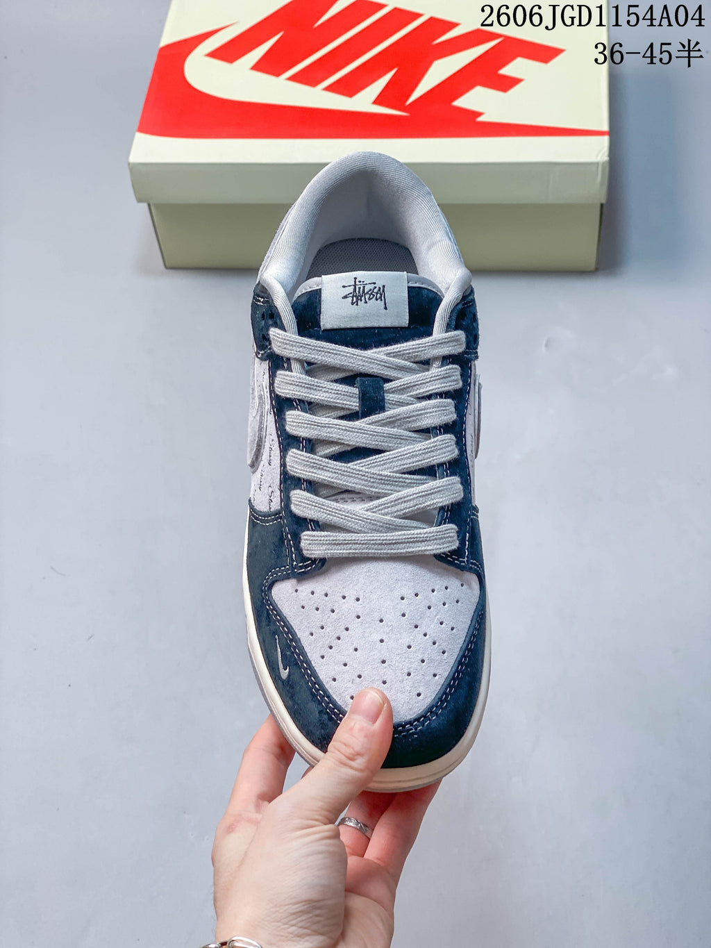 Top view of a low-top sneaker with light laces and perforated toe