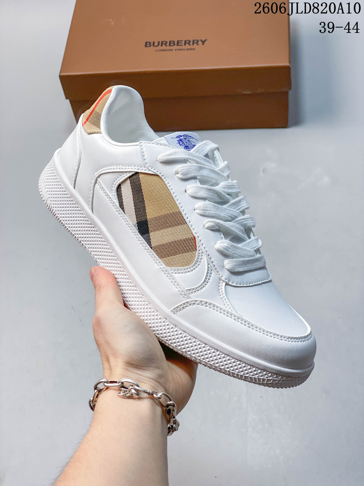 Angled view of a white sneaker with beige check-pattern side panel