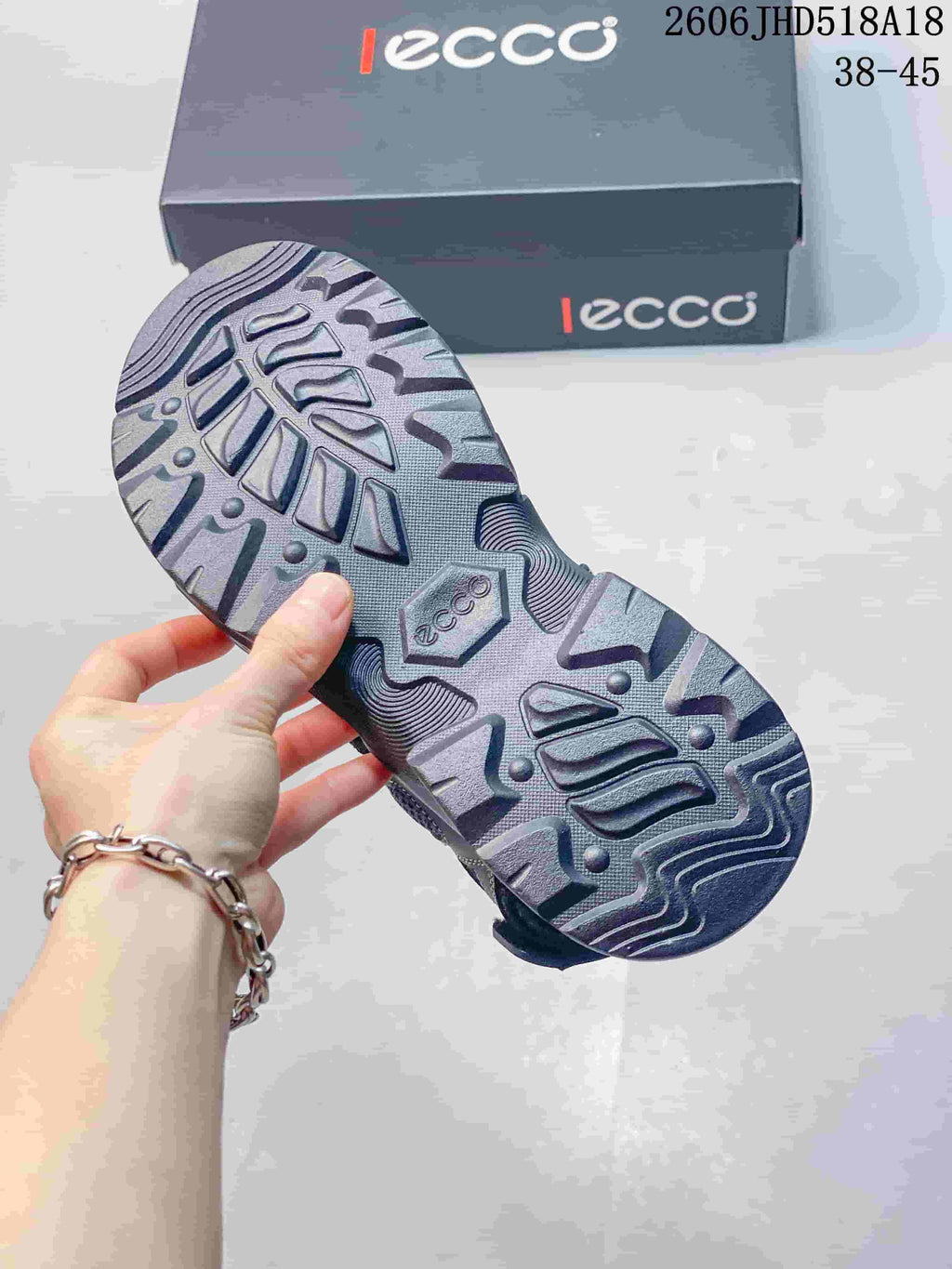 Close-up of the patterned outsole on a gray sandal