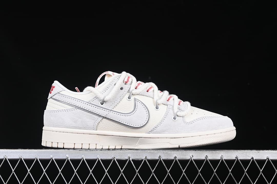 Side profile of a low-top sneaker with a gray Swoosh