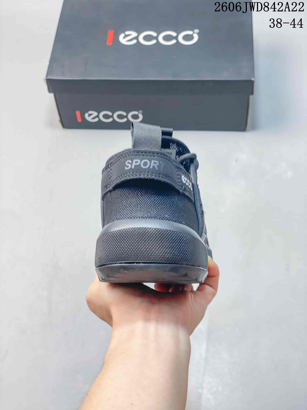 Rear view of a gray sneaker with a heel pull tab