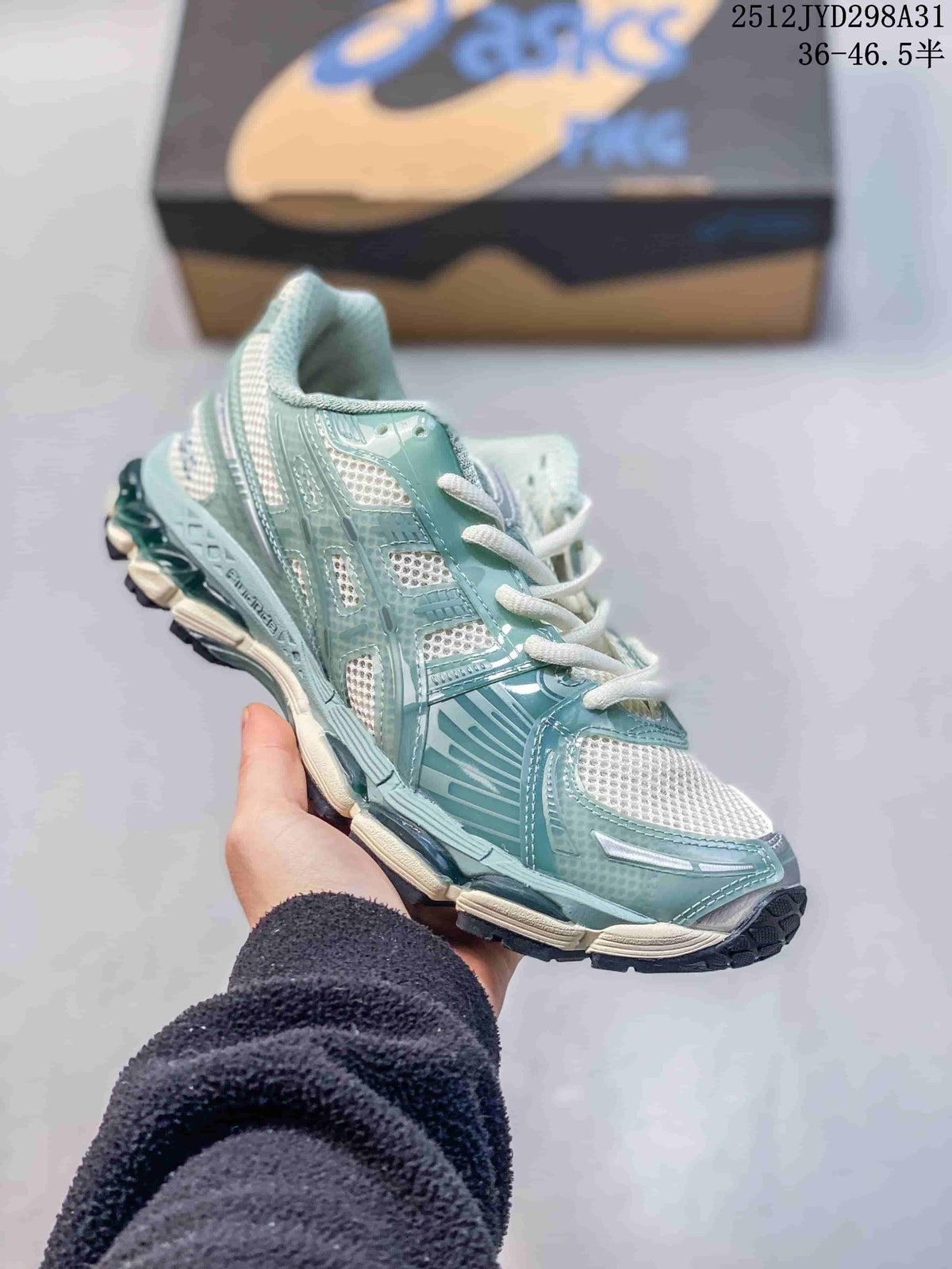 Close side view of a pale aqua and white running sneaker.