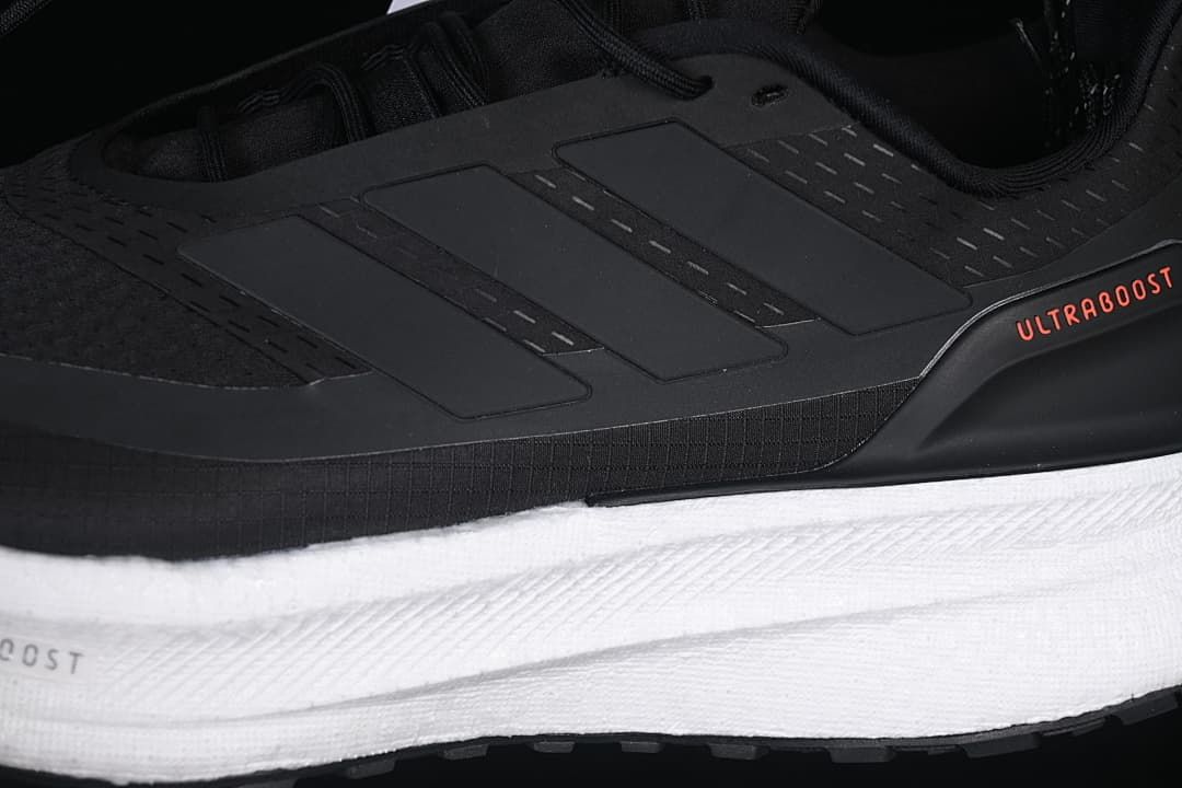 Close-up of the black side panel, adidas stripes, and white midsole.