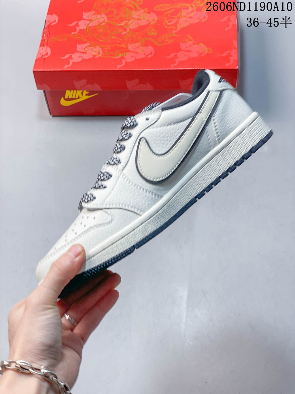 Side profile of the off-white Air Jordan 1 Low with dark patterned laces